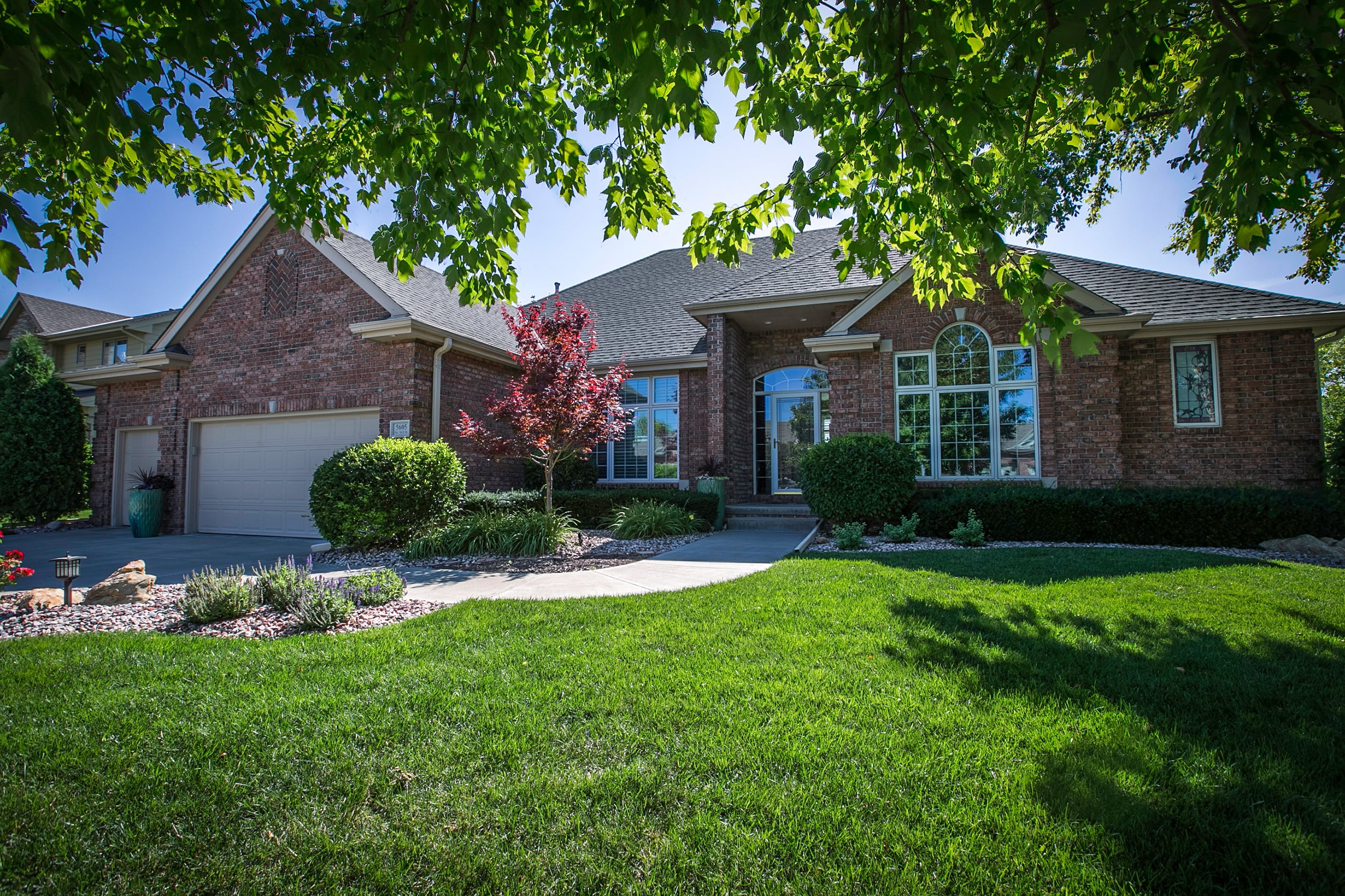 house with beautiful green landscape and trees